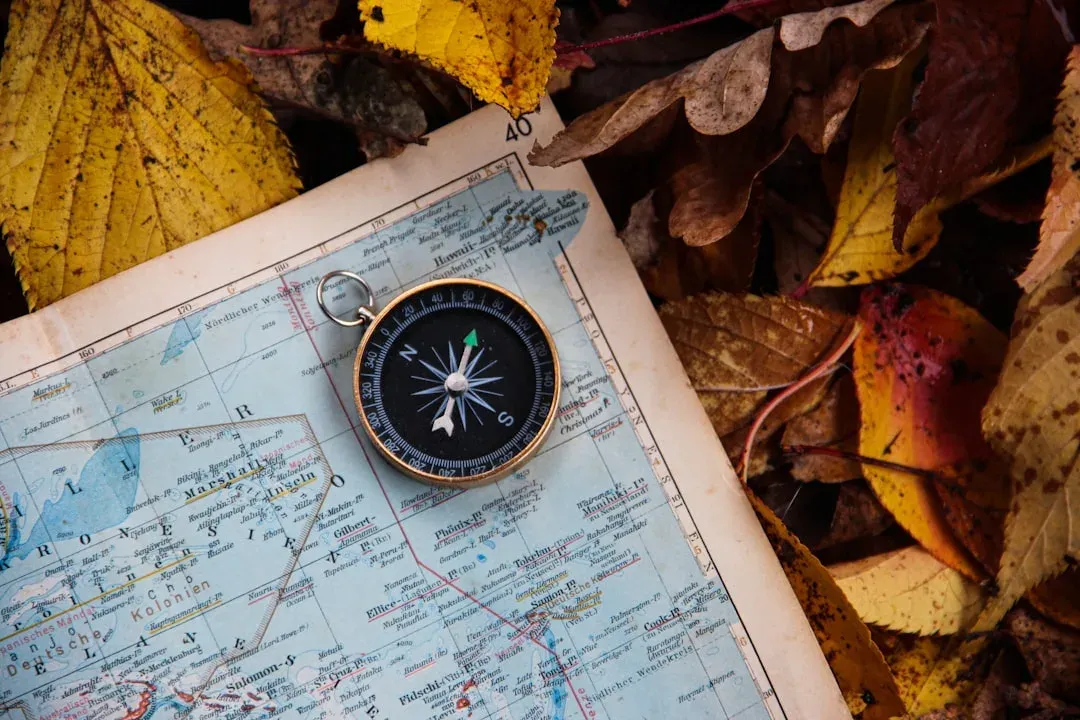 hiker uses map and compass for navigation on the trail